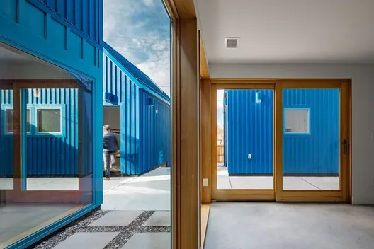 Commercial building with a blue painted shipping-container facade
