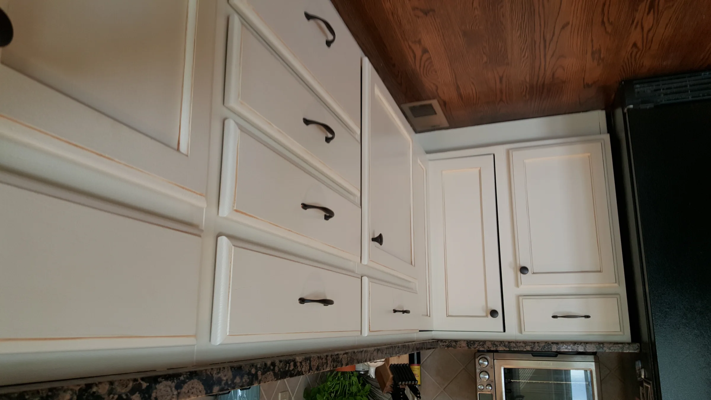 White shaker kitchen cabinets with crown molding after painting