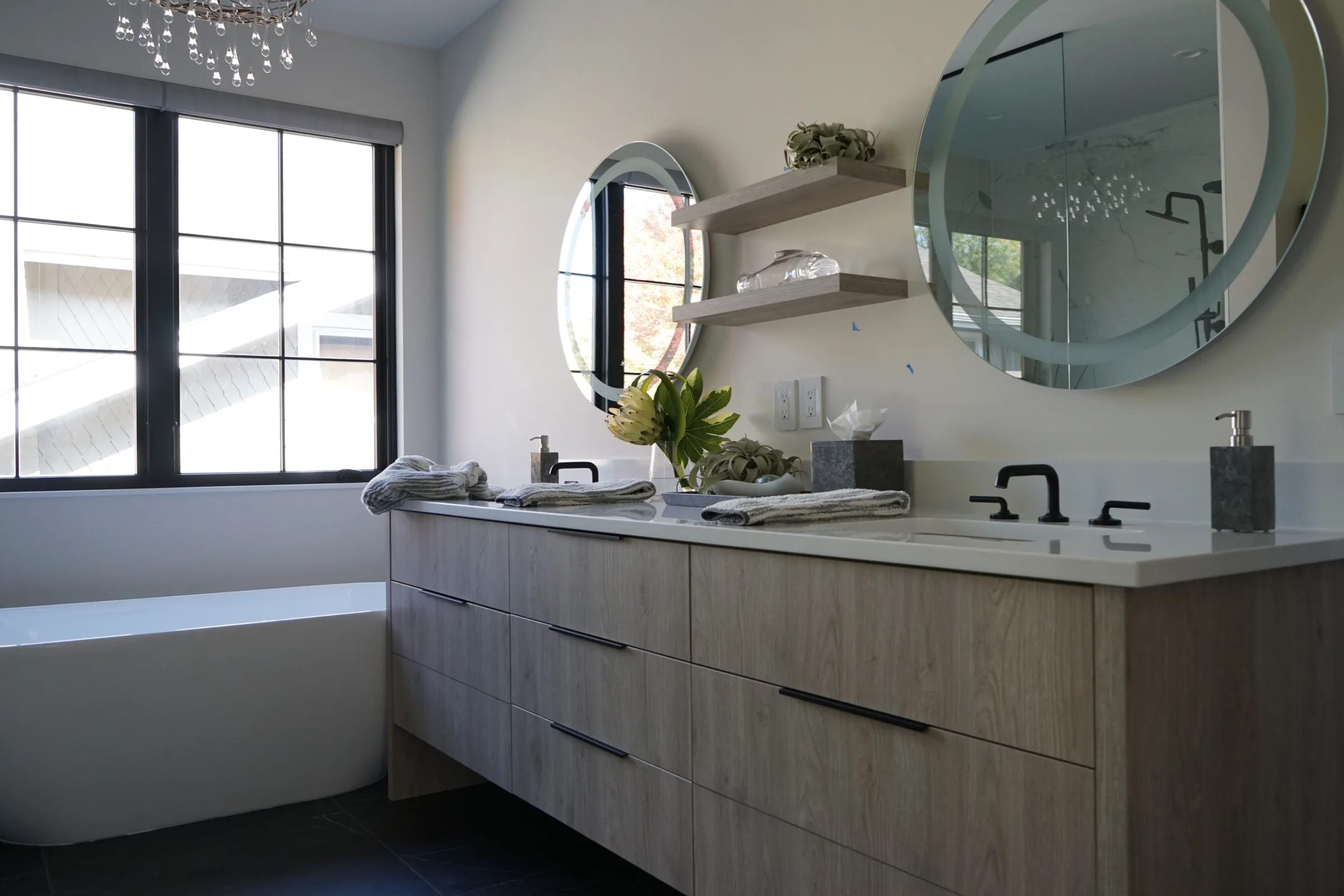 Bathroom with a double vanity and round mirrors